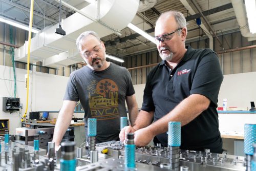 New Concept Technology employees working with a tooling machine