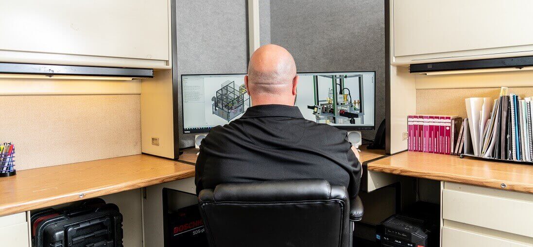NCT engineer working on a computer at his desk